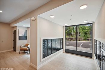 a hallway with a large glass door leading to a parking lot